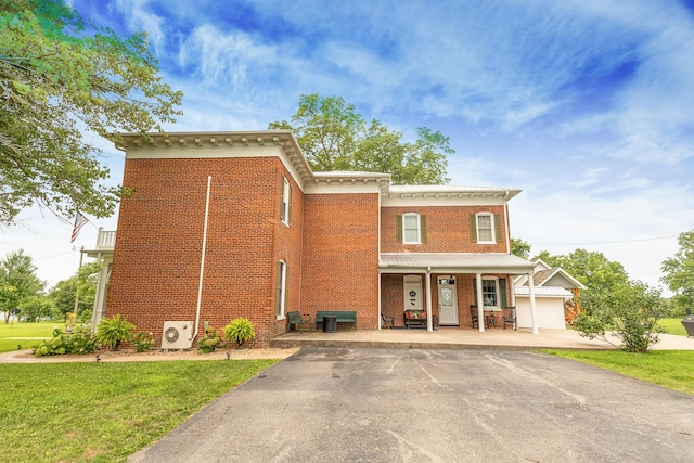 1001 Randolph St, Glasgow, MO 65254 - view of front of property with brick siding, covered porch, a front yard, and asphalt driveway