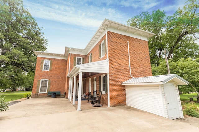 1001 Randolph St, Glasgow, MO 65254 - rear view of property featuring brick siding and a patio