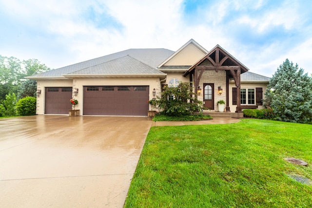 3903 Foxcreek Way, Columbia, MO 65203 - view of front of home featuring an attached garage, driveway, a front lawn, and stucco siding