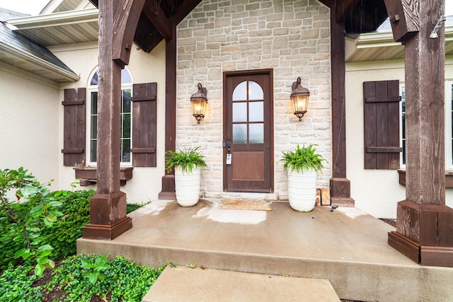3903 Foxcreek Way, Columbia, MO 65203 - view of exterior entry featuring stucco siding, stone siding, and covered porch