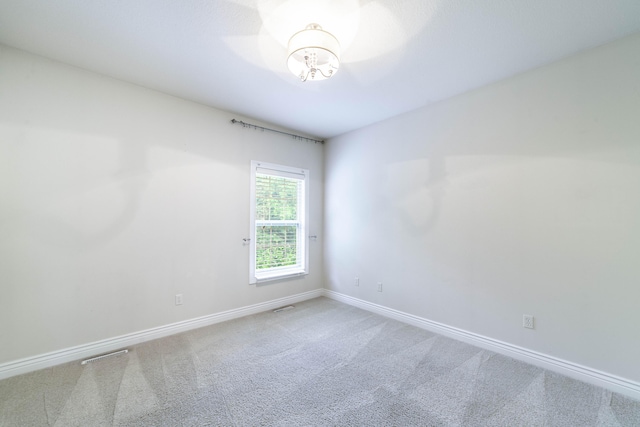 3903 Foxcreek Way, Columbia, MO 65203 - carpeted empty room with baseboards and a chandelier