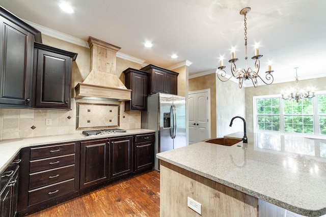 3903 Foxcreek Way, Columbia, MO 65203 - kitchen with custom range hood, a chandelier, stainless steel appliances, ornamental molding, and dark wood finished floors