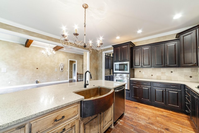 3903 Foxcreek Way, Columbia, MO 65203 - kitchen with a chandelier, stainless steel appliances, light wood finished floors, crown molding, and light stone countertops