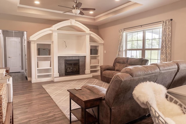 3045 State Rd, Aa, Holts Summit, MO 65043 - living area featuring a raised ceiling, ceiling fan, wood finished floors, crown molding, and a fireplace