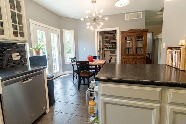 3045 State Rd, Aa, Holts Summit, MO 65043 - kitchen featuring stainless steel dishwasher, dark countertops, backsplash, dark tile patterned floors, and glass insert cabinets