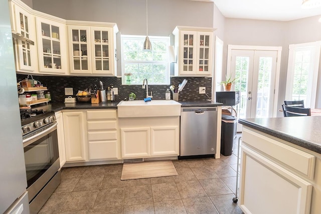 3045 State Rd, Aa, Holts Summit, MO 65043 - kitchen featuring stainless steel appliances, plenty of natural light, backsplash, and dark countertops
