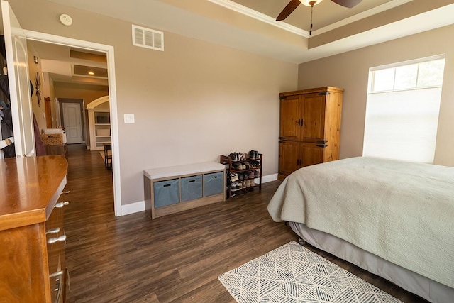 3045 State Rd, Aa, Holts Summit, MO 65043 - bedroom featuring a raised ceiling, dark wood finished floors, arched walkways, and crown molding