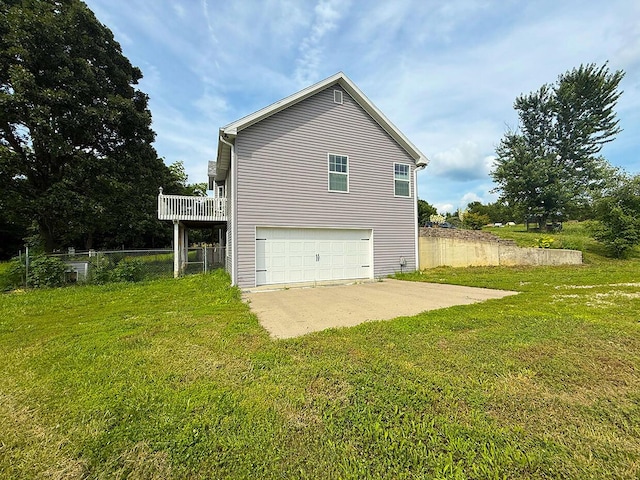 3045 State Rd, Aa, Holts Summit, MO 65043 - rear view of property featuring a garage, a yard, a wooden deck, and driveway
