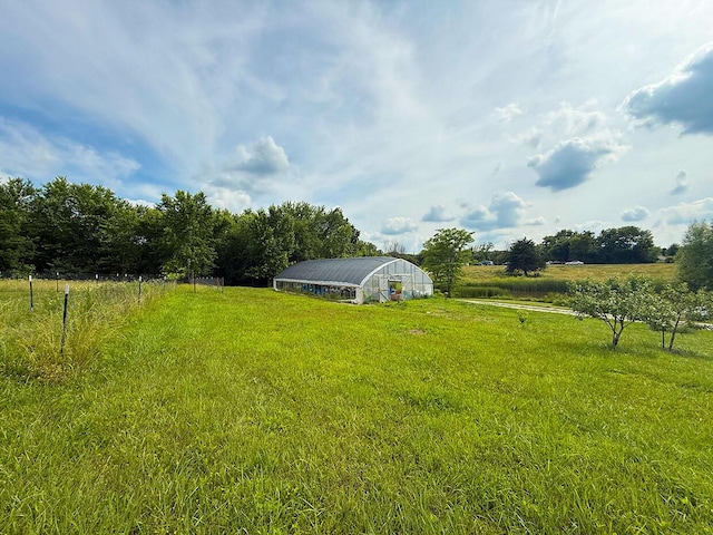3045 State Rd, Aa, Holts Summit, MO 65043 - view of grassy yard featuring an outdoor structure, a view of rural / pastoral area, and an exterior structure