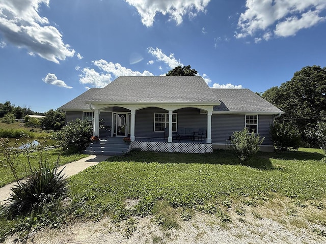 3045 State Rd, Aa, Holts Summit, MO 65043 - bungalow with covered porch, a front lawn, and a shingled roof