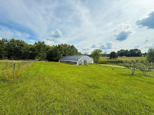 3045 State Rd, Aa, Holts Summit, MO 65043 - view of grassy yard with an outbuilding, a greenhouse, and a view of rural / pastoral area