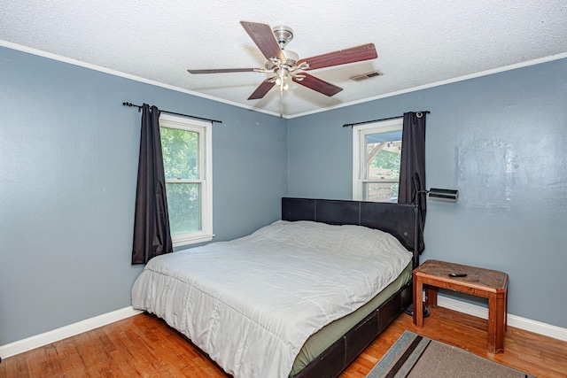 4741 E N Rte E, Columbia, MO 65202 - bedroom with wood finished floors, a textured ceiling, ornamental molding, and a ceiling fan