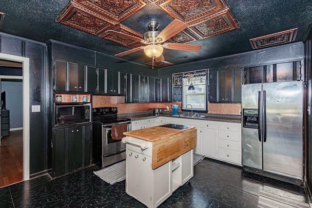 4741 E N Rte E, Columbia, MO 65202 - kitchen featuring stainless steel appliances, wooden counters, a ceiling fan, white cabinets, and a kitchen island