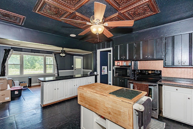 4741 E N Rte E, Columbia, MO 65202 - kitchen with electric stove, ceiling fan, black microwave, white cabinetry, and a center island