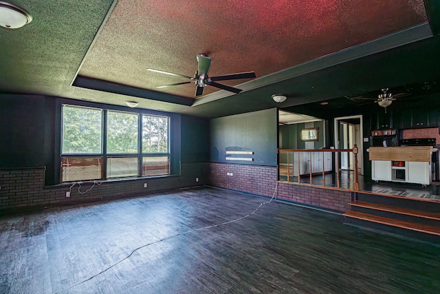 4741 E N Rte E, Columbia, MO 65202 - unfurnished room featuring ceiling fan, a tray ceiling, brick wall, wood finished floors, and wainscoting