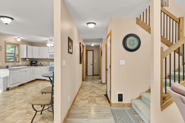 28 Hamilton Way, Sunrise Beach, MO 65079 - hallway featuring stairs and baseboards