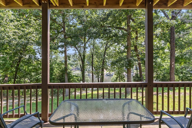 28 Hamilton Way, Sunrise Beach, MO 65079 - wooden terrace with outdoor dining space, a water view, and view of wooded area
