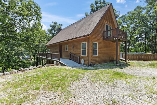 28 Hamilton Way, Sunrise Beach, MO 65079 - view of property exterior featuring a deck, a shingled roof, and a balcony