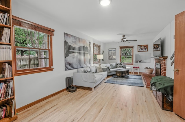 1000 Yale Dr, Columbia, MO 65203 - living room featuring ceiling fan, wood finished floors, and a brick fireplace