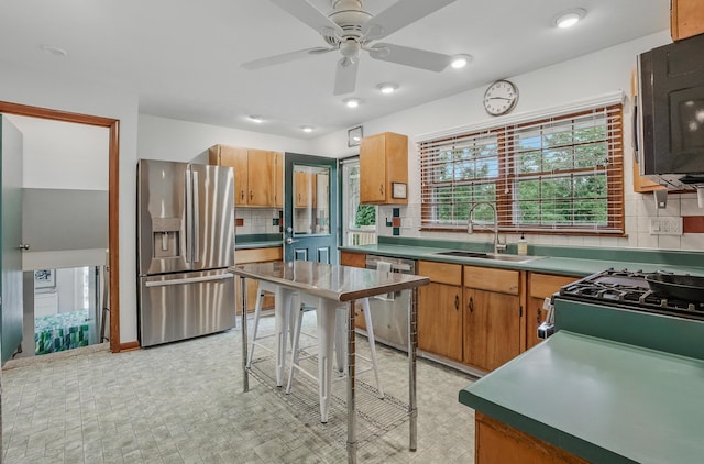 1000 Yale Dr, Columbia, MO 65203 - kitchen featuring stainless steel appliances, decorative backsplash, a ceiling fan, and brown cabinets