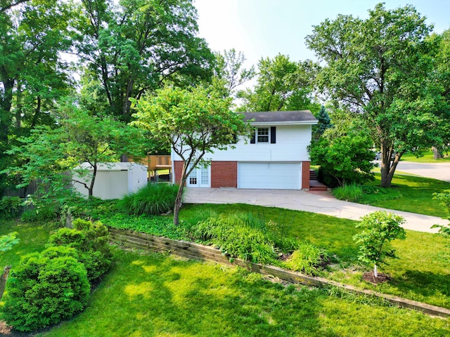 1000 Yale Dr, Columbia, MO 65203 - view of front facade with an attached garage, a front lawn, brick siding, and driveway