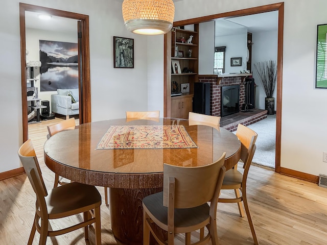 1000 Yale Dr, Columbia, MO 65203 - dining space with light wood-style floors and a fireplace