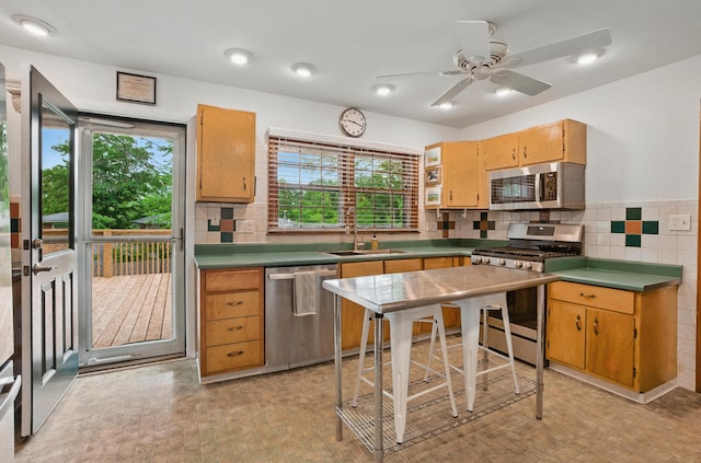 1000 Yale Dr, Columbia, MO 65203 - kitchen with stainless steel appliances, backsplash, and ceiling fan