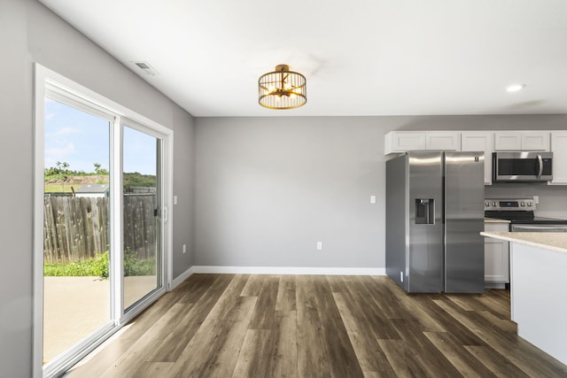 3306 Tuscany, Columbia, MO 65202 - kitchen with stainless steel appliances, dark wood-style floors, light countertops, recessed lighting, and a chandelier