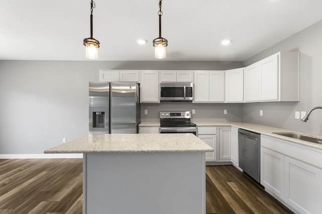 3306 Tuscany, Columbia, MO 65202 - kitchen with appliances with stainless steel finishes, a kitchen island, dark wood-style floors, recessed lighting, and light stone counters