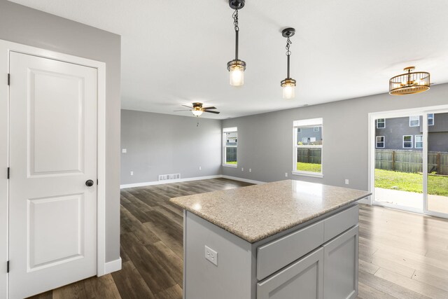 3306 Tuscany, Columbia, MO 65202 - kitchen featuring dark wood-type flooring, a ceiling fan, and decorative light fixtures