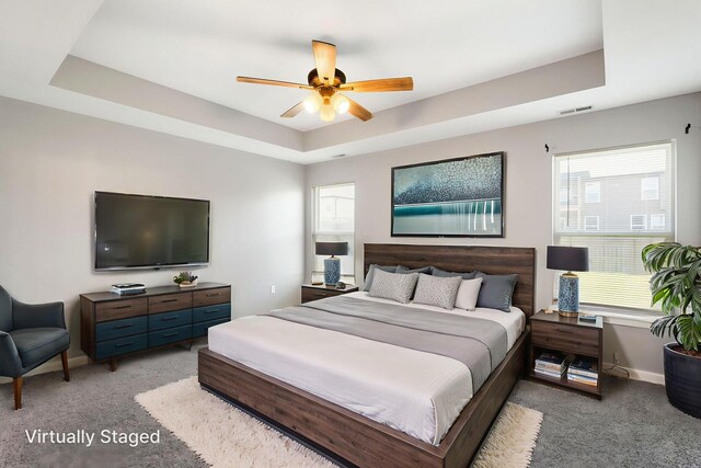 3306 Tuscany, Columbia, MO 65202 - bedroom featuring a tray ceiling, light colored carpet, and a ceiling fan