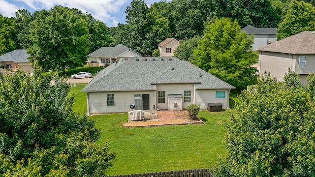 6610 Chrissula Ln, Columbia, MO 65203 - back of property featuring a patio area, a lawn, and a shingled roof