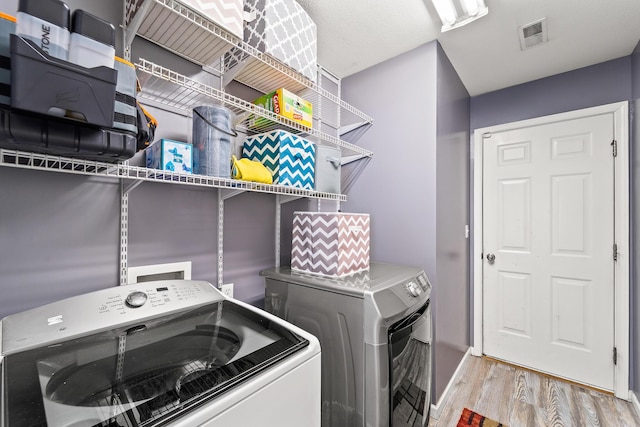 6610 Chrissula Ln, Columbia, MO 65203 - washroom featuring washer and dryer and wood finished floors