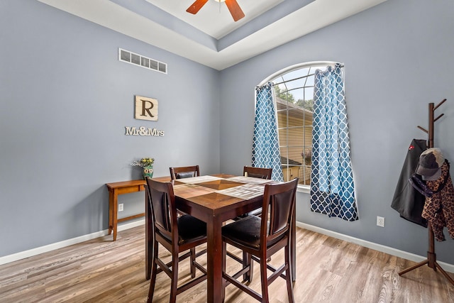 6610 Chrissula Ln, Columbia, MO 65203 - dining space with light wood-style flooring, a ceiling fan, and a raised ceiling