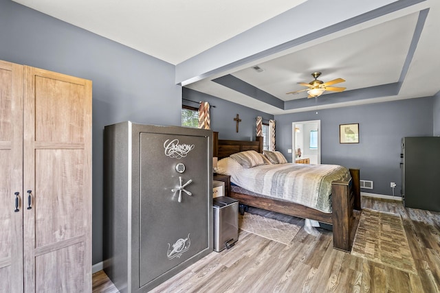 6610 Chrissula Ln, Columbia, MO 65203 - bedroom with a raised ceiling, wood finished floors, and a ceiling fan