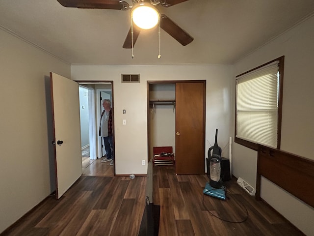 6009 E Eric Ln, Columbia, MO 65202 - unfurnished bedroom with wood finished floors, ornamental molding, a closet, and a ceiling fan