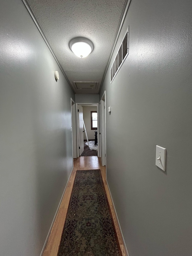 6009 E Eric Ln, Columbia, MO 65202 - hall featuring light wood finished floors, a textured ceiling, and attic access
