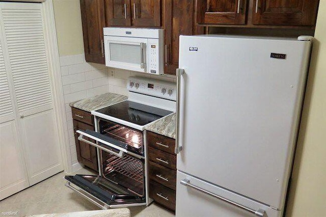 1902 Park Deville Pl, Columbia, MO 65203 - kitchen with white appliances, dark brown cabinets, and light countertops