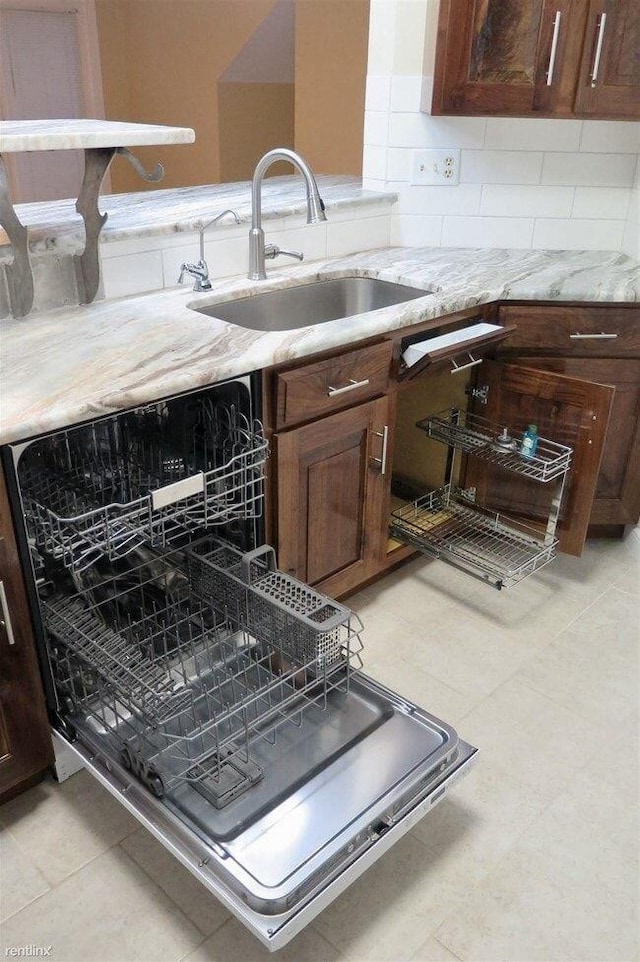 1902 Park Deville Pl, Columbia, MO 65203 - kitchen with tasteful backsplash, light stone countertops, dishwashing machine, and light tile patterned floors