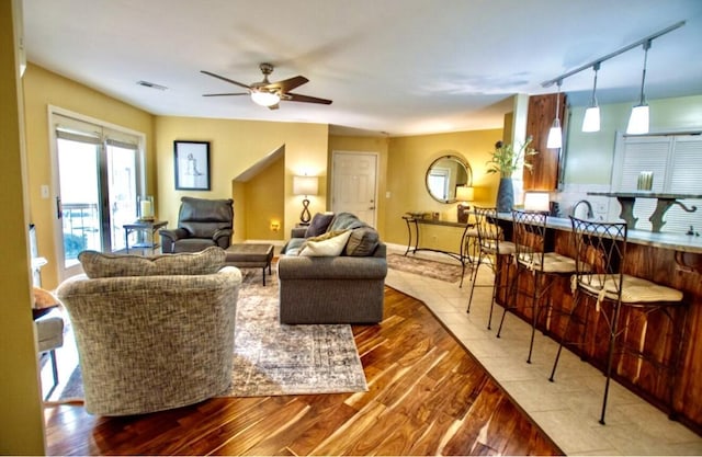 1902 Park Deville Pl, Columbia, MO 65203 - living room featuring wood-type flooring, a ceiling fan, and rail lighting