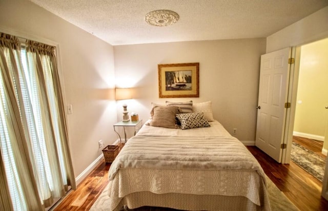 1902 Park Deville Pl, Columbia, MO 65203 - bedroom featuring dark wood-type flooring and a textured ceiling