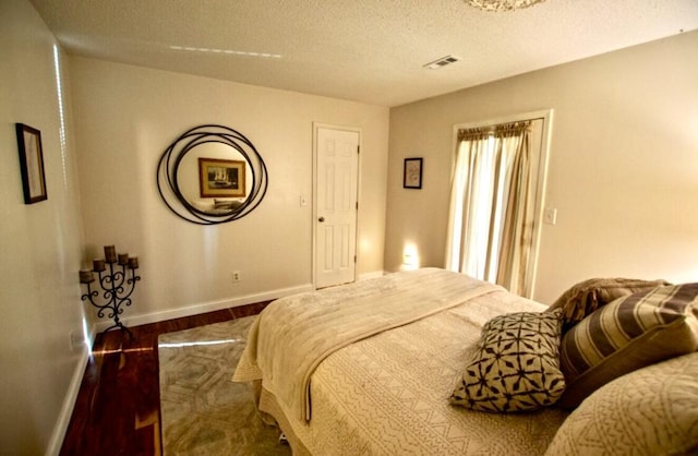 1902 Park Deville Pl, Columbia, MO 65203 - bedroom featuring wood finished floors and a textured ceiling