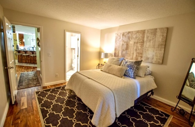 1902 Park Deville Pl, Columbia, MO 65203 - bedroom with wood finished floors, a textured ceiling, and ensuite bathroom