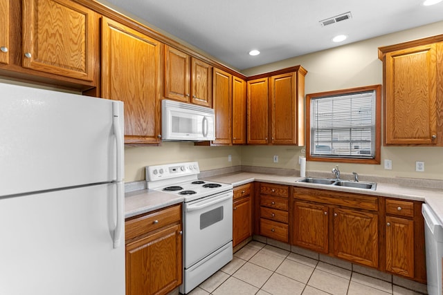 2208-2210 Shamrock Dr, Columbia, MO 65202 - kitchen with white appliances, light tile patterned flooring, light countertops, brown cabinets, and recessed lighting