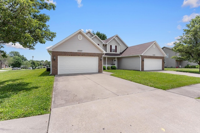 2208-2210 Shamrock Dr, Columbia, MO 65202 - traditional-style house featuring brick siding, a front lawn, and driveway