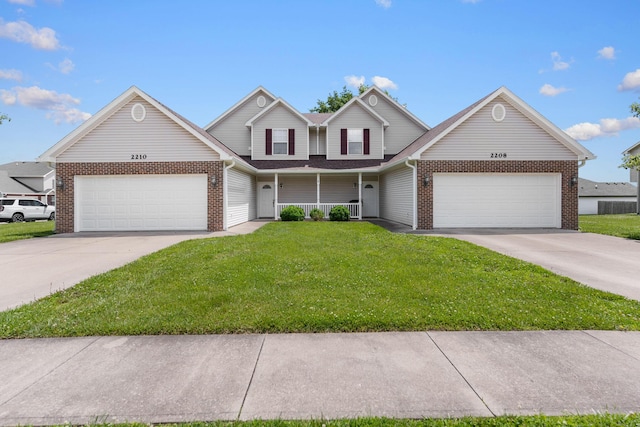2208-2210 Shamrock Dr, Columbia, MO 65202 - traditional home with a garage, concrete driveway, brick siding, a front lawn, and covered porch