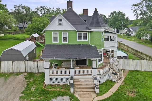 704 N Jefferson St, Mexico, MO 65265 - view of front of property with a shingled roof, a fenced backyard, a porch, and a chimney