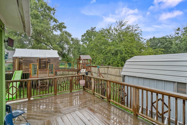 704 N Jefferson St, Mexico, MO 65265 - wooden deck with a playground and view of wooded area