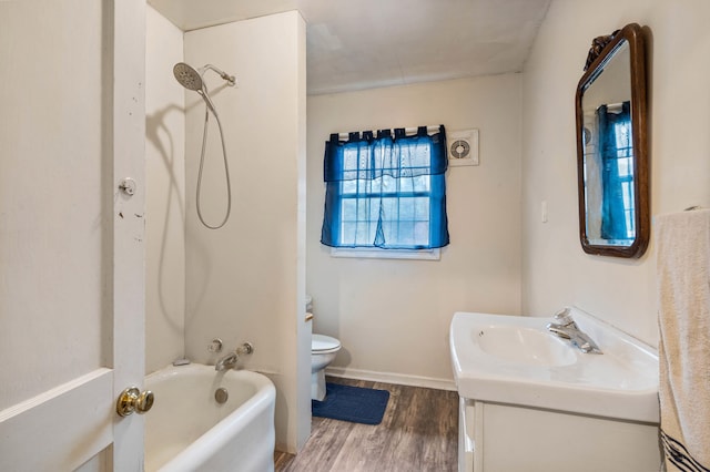 704 N Jefferson St, Mexico, MO 65265 - full bath with wood finished floors, vanity, and tub / shower combination