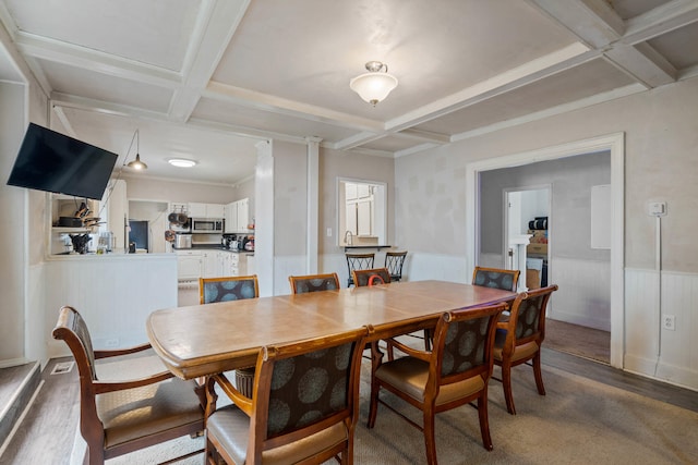 704 N Jefferson St, Mexico, MO 65265 - dining space featuring coffered ceiling, wainscoting, beamed ceiling, and wood finished floors
